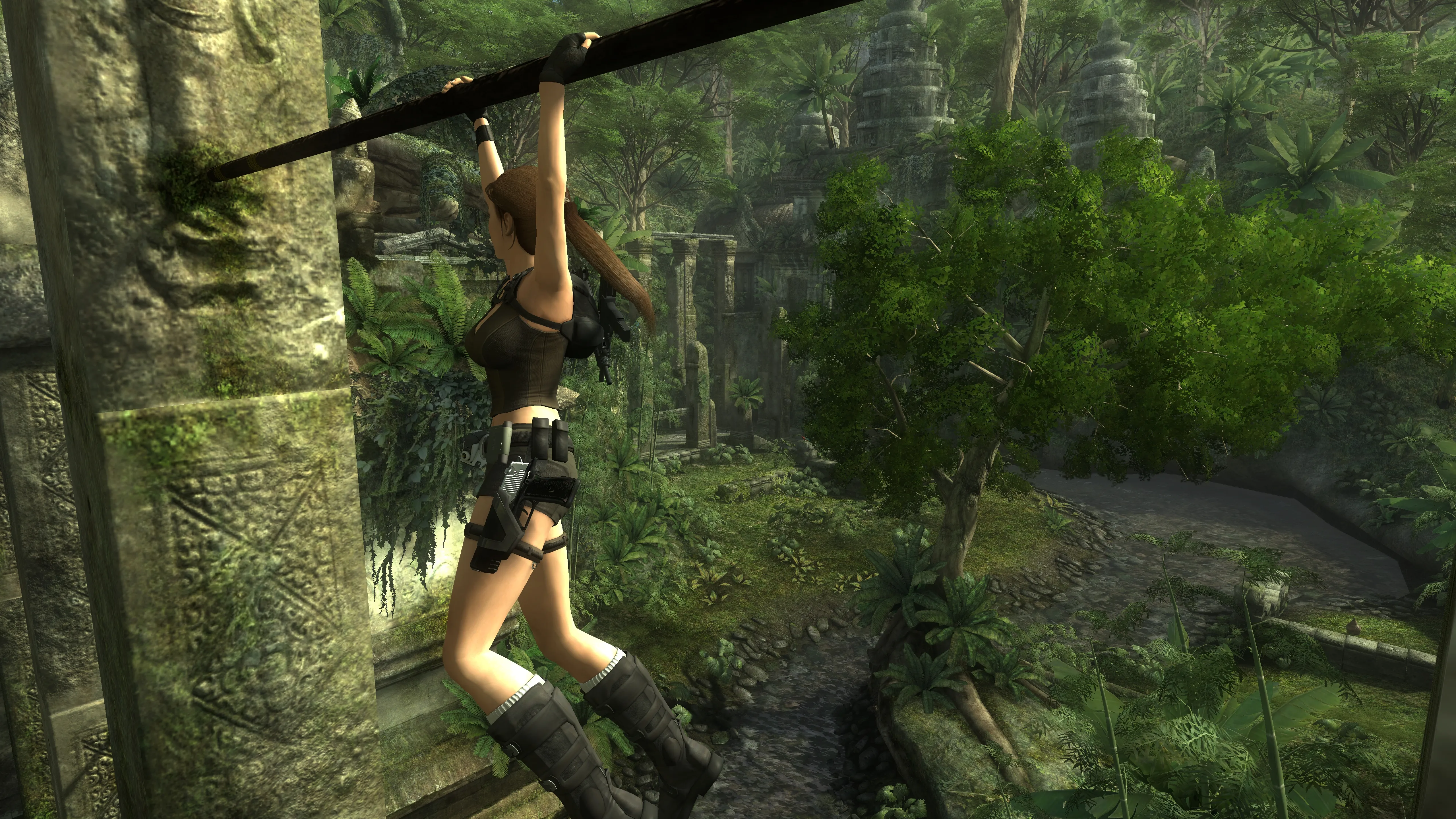 Lara hanging from a pole in a tower