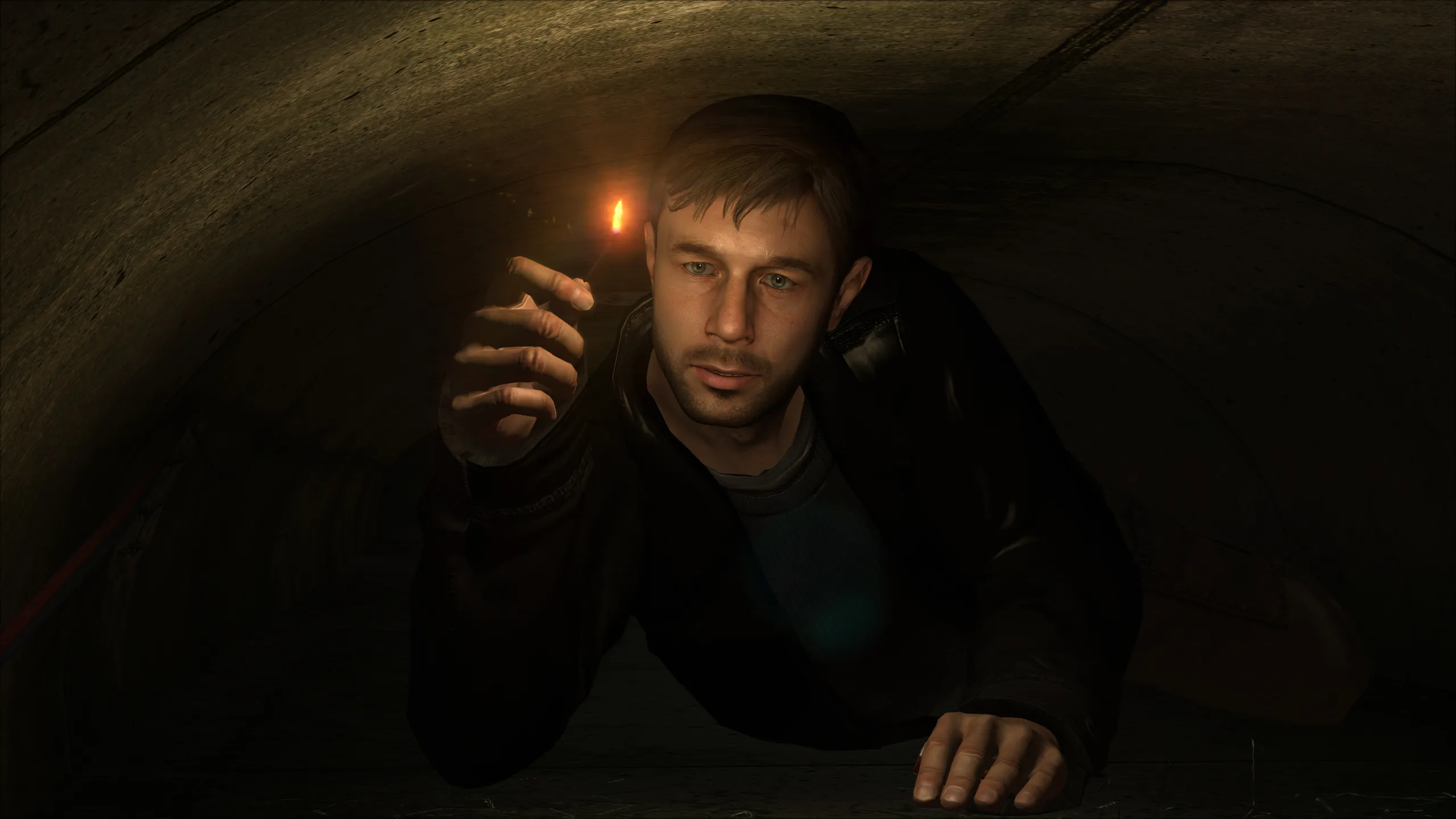 Ethan with a lit match in a tunnel