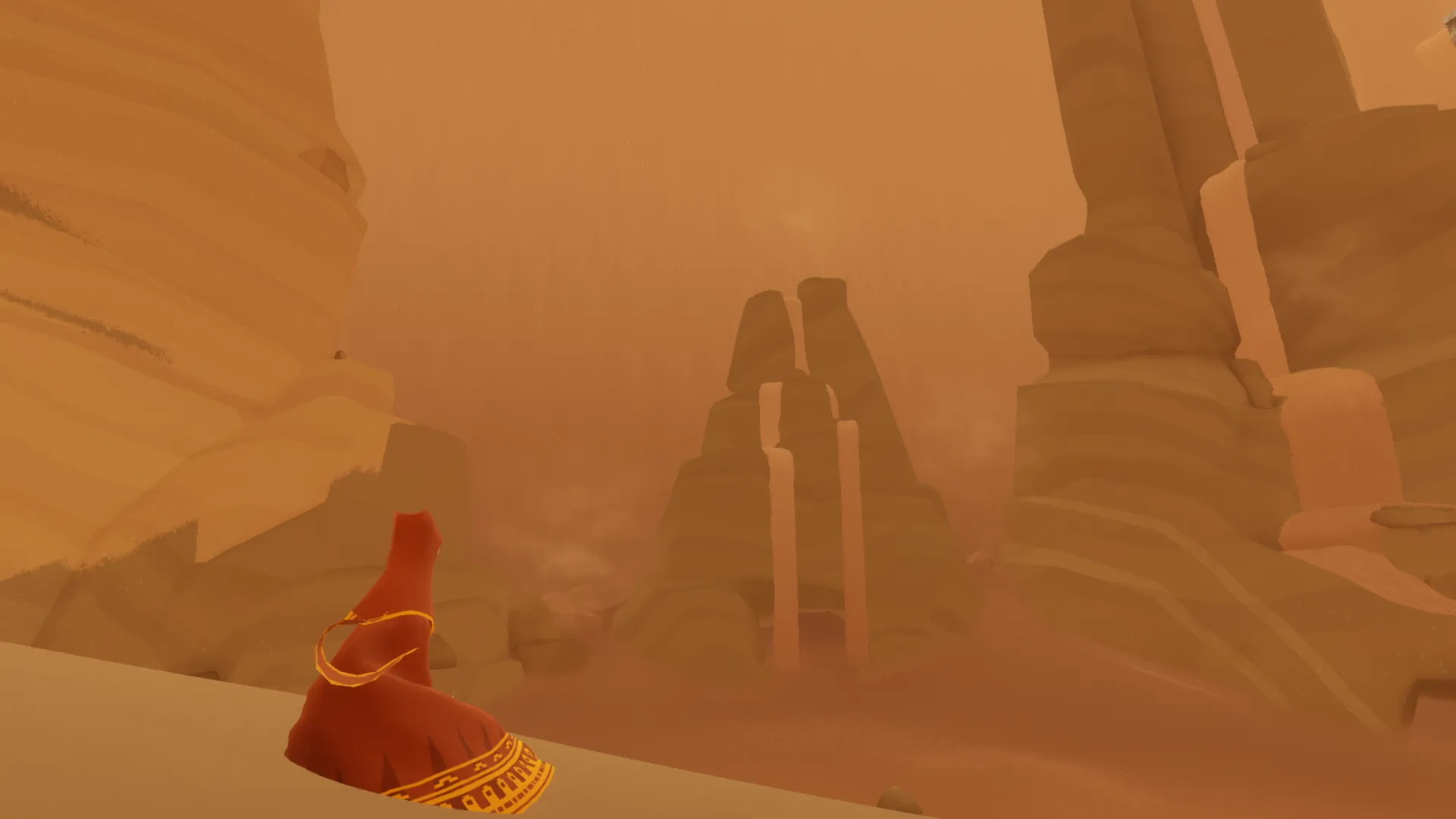 The traveler looks out at a monument over a sand dune